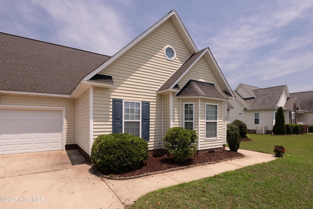 view of front facade featuring central AC, a front lawn, and a garage