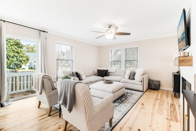 living room with ceiling fan, wood-type flooring, and ornamental molding