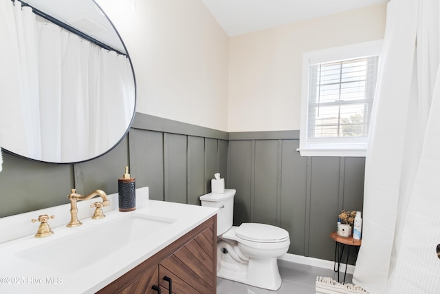 bathroom with tile patterned floors, vanity, and toilet