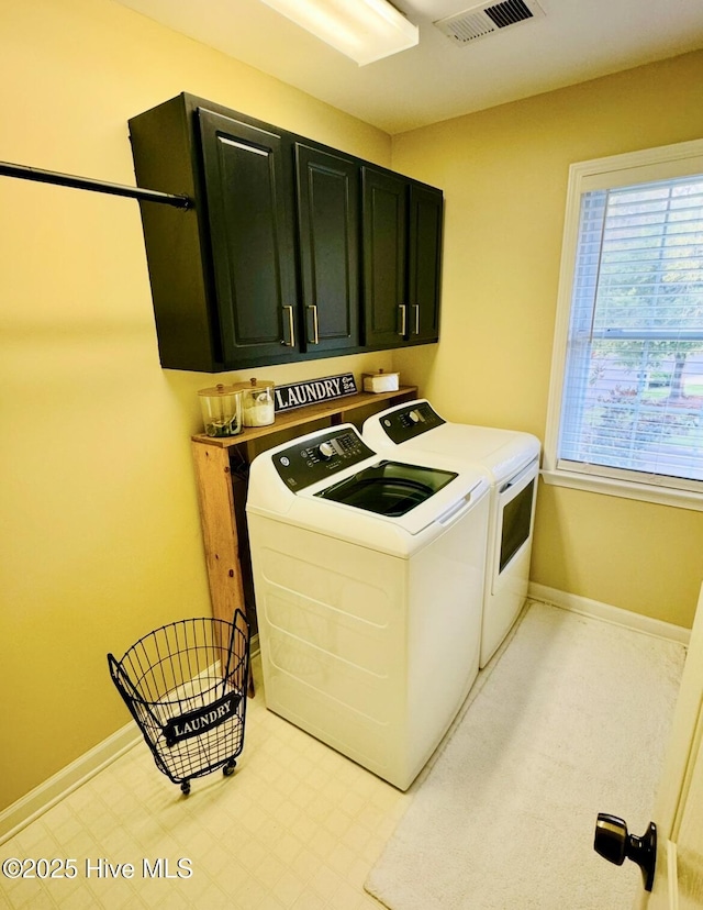 washroom featuring independent washer and dryer and cabinets