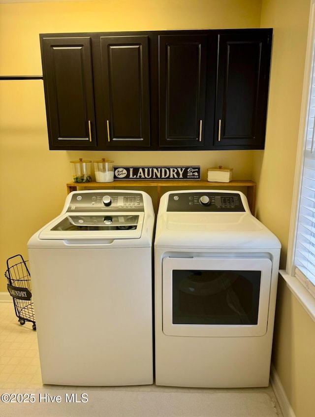 laundry area featuring cabinets and separate washer and dryer