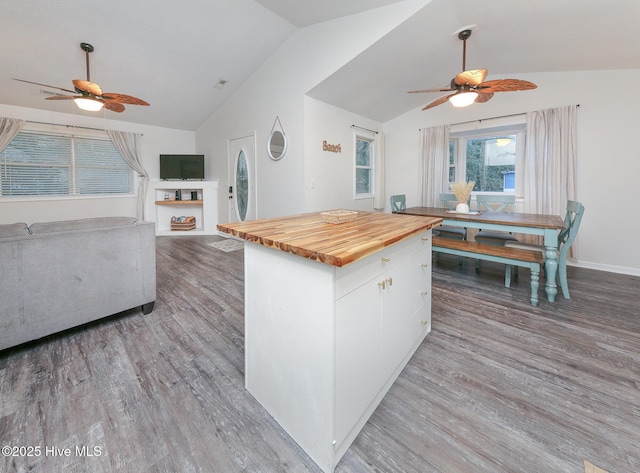 kitchen with hardwood / wood-style flooring, lofted ceiling, wood counters, white cabinetry, and ceiling fan