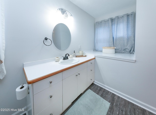 bathroom with vanity and hardwood / wood-style flooring