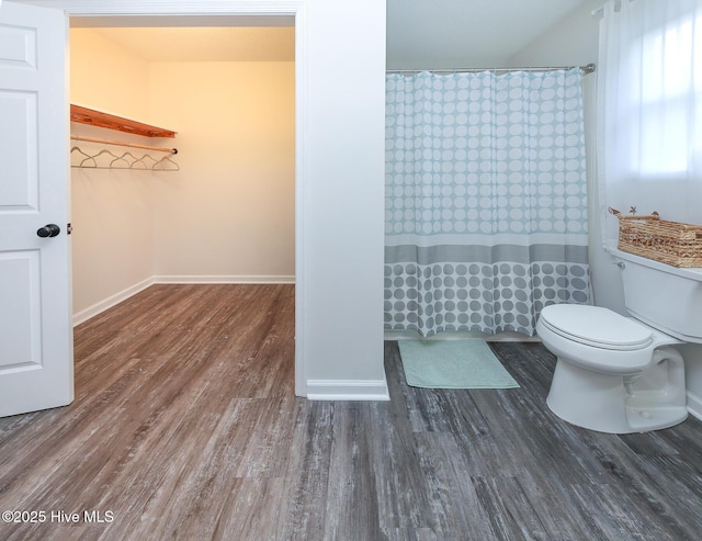 bathroom featuring toilet and wood-type flooring