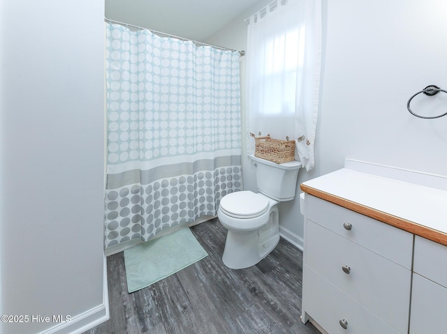 bathroom with hardwood / wood-style floors, vanity, and toilet