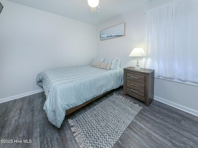 bedroom with ceiling fan and dark wood-type flooring