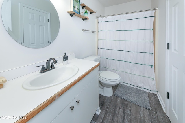 bathroom with toilet, vanity, a shower with shower curtain, and hardwood / wood-style floors