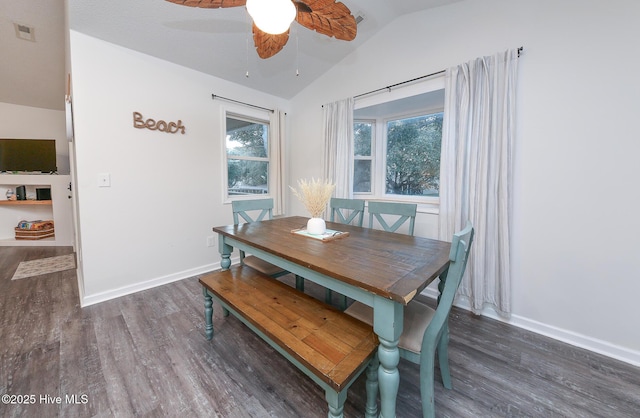 dining room with lofted ceiling, dark hardwood / wood-style flooring, and ceiling fan