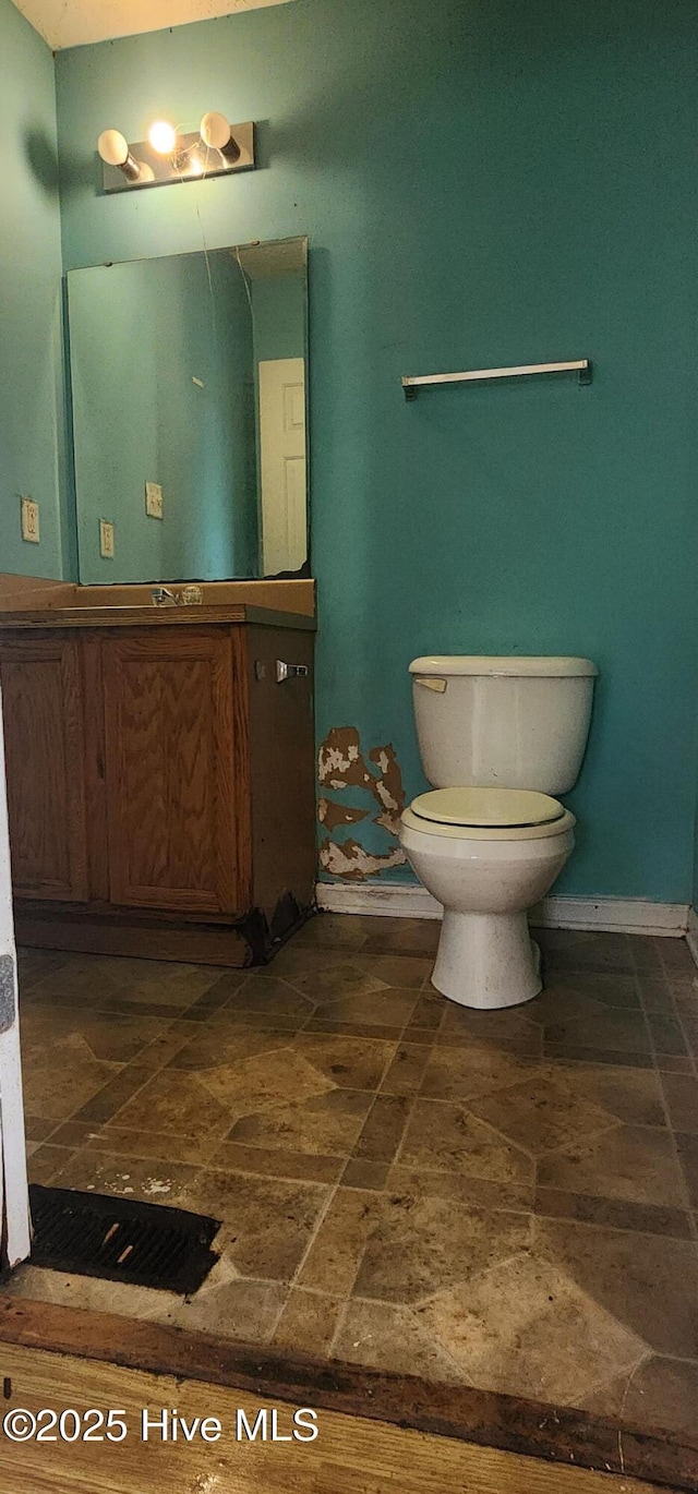 bathroom featuring toilet and vanity