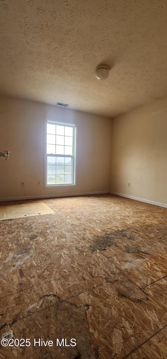 empty room featuring a textured ceiling