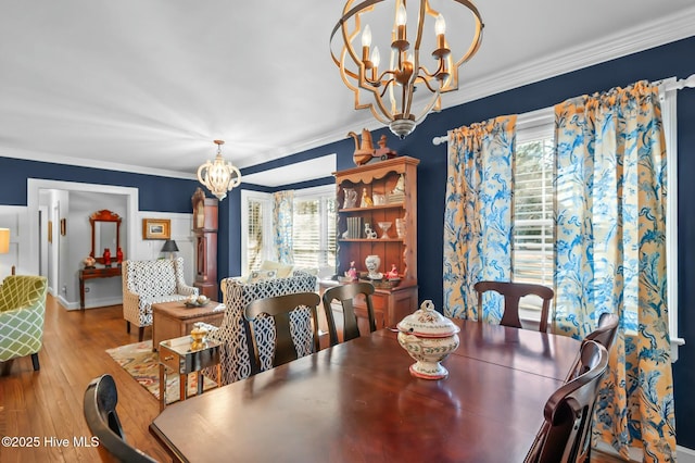 dining space with a notable chandelier, crown molding, and plenty of natural light