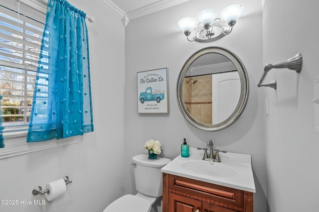 bathroom featuring ornamental molding, vanity, and toilet