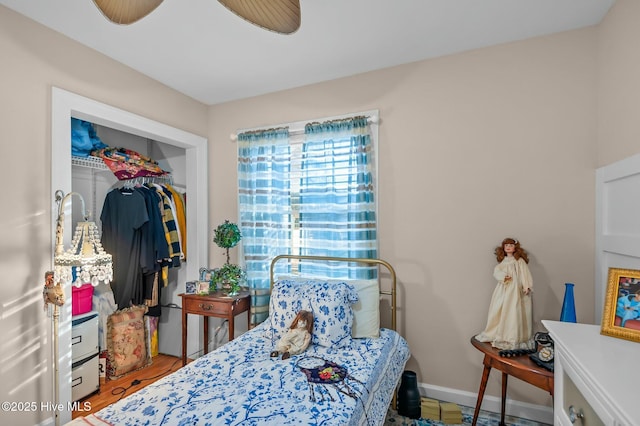 bedroom with ceiling fan and a closet