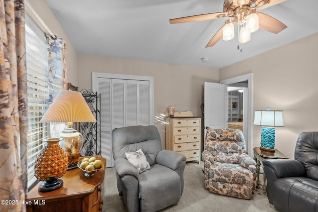 living room featuring ceiling fan and carpet