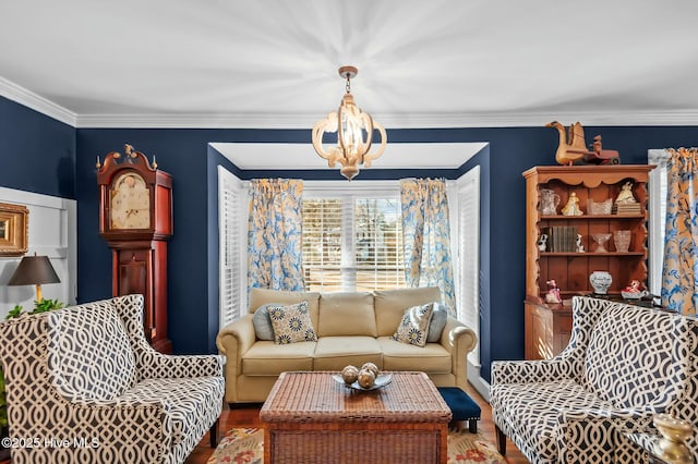 living room with a chandelier, hardwood / wood-style flooring, and crown molding