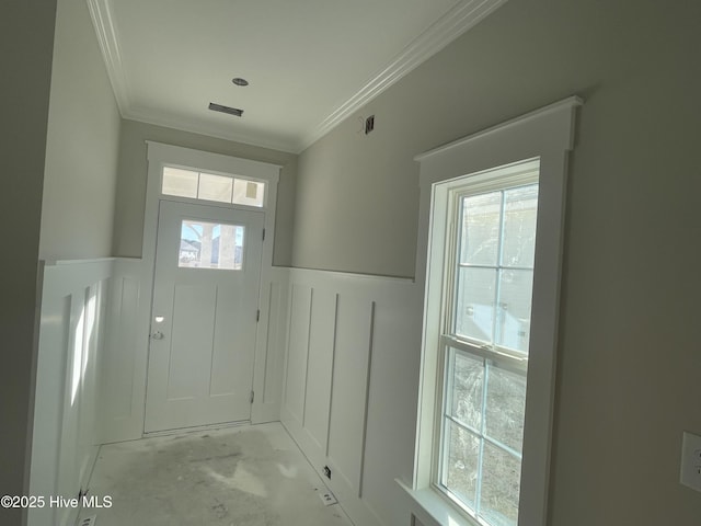 doorway featuring crown molding and a healthy amount of sunlight