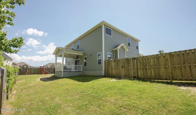 back of house with a yard