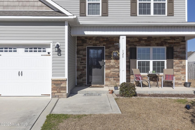 property entrance with a porch and a garage