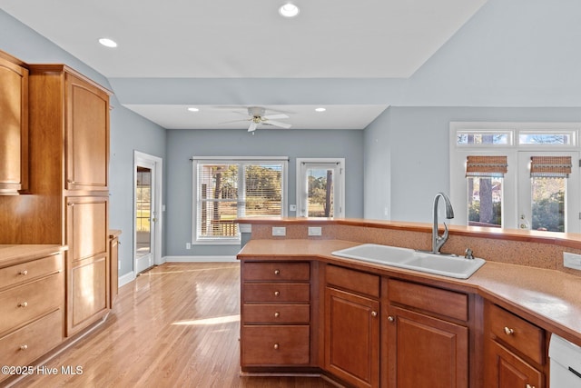 kitchen with ceiling fan, light wood-type flooring, sink, and white dishwasher