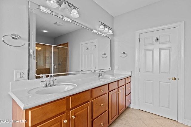 bathroom with vanity, tile patterned floors, and a shower with door