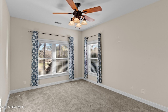 unfurnished room featuring light carpet and ceiling fan