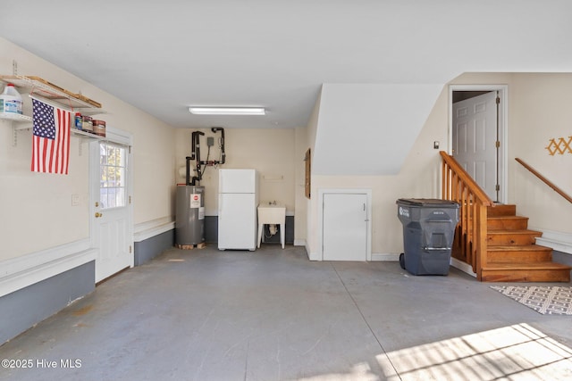 garage featuring electric water heater and white fridge