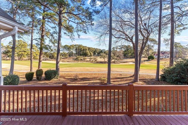 wooden deck featuring a lawn