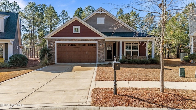 craftsman house with cooling unit and a garage