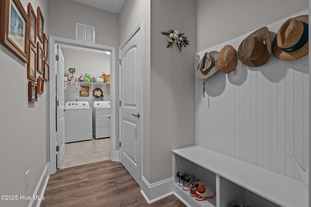 mudroom with washing machine and dryer and hardwood / wood-style floors