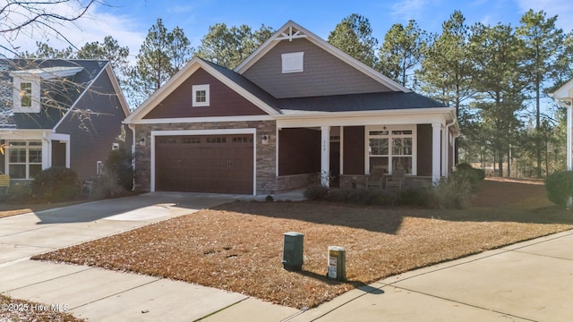 craftsman-style home with covered porch and a garage