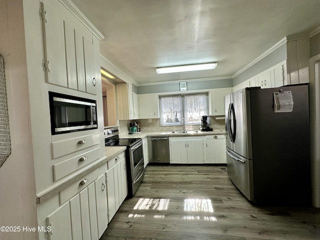 kitchen featuring white cabinetry, appliances with stainless steel finishes, and light hardwood / wood-style flooring