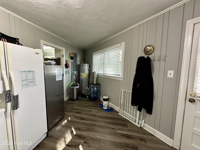 interior space featuring crown molding, stainless steel refrigerator, dark hardwood / wood-style flooring, electric water heater, and white fridge