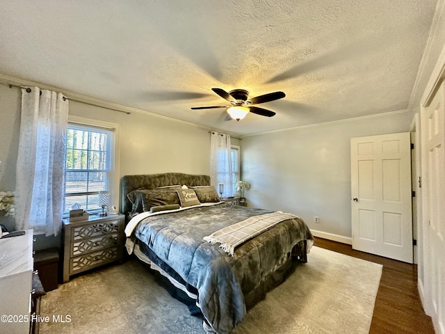 bedroom featuring crown molding, ceiling fan, dark wood-type flooring, and a textured ceiling