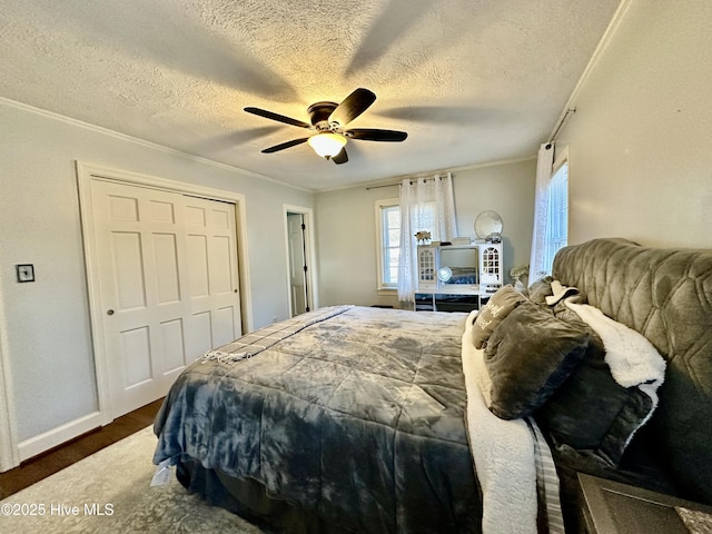 bedroom with crown molding, ceiling fan, dark hardwood / wood-style floors, a textured ceiling, and a closet