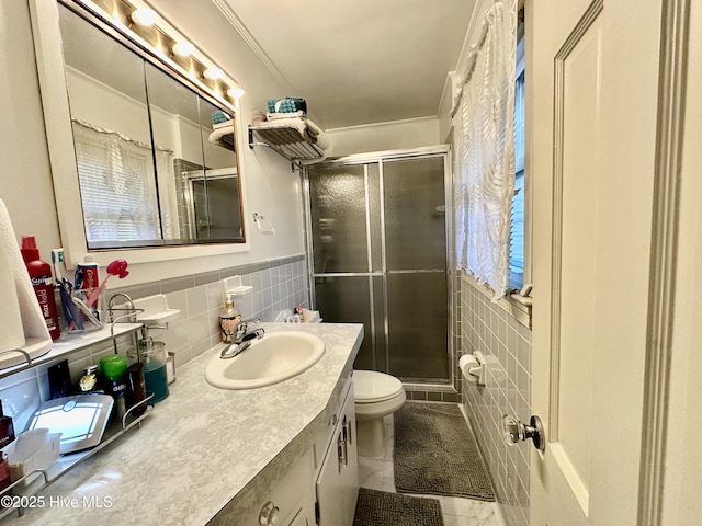 bathroom featuring tile walls, vanity, an enclosed shower, toilet, and crown molding