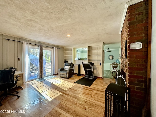 interior space with a textured ceiling, a fireplace, and light hardwood / wood-style floors