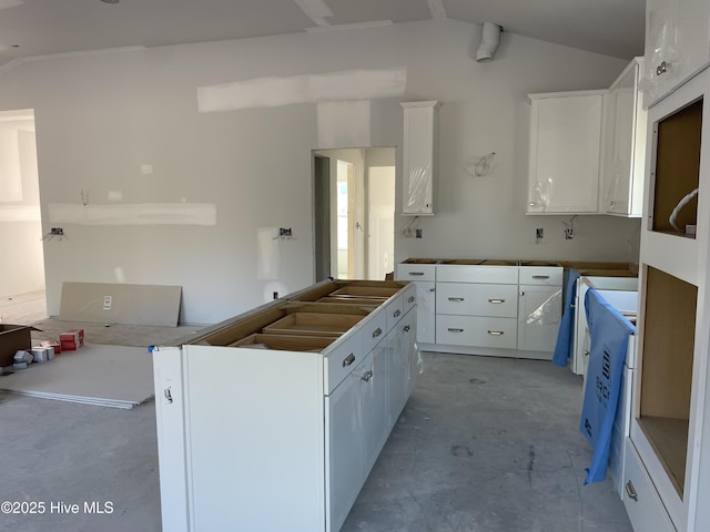 kitchen with white cabinetry and vaulted ceiling