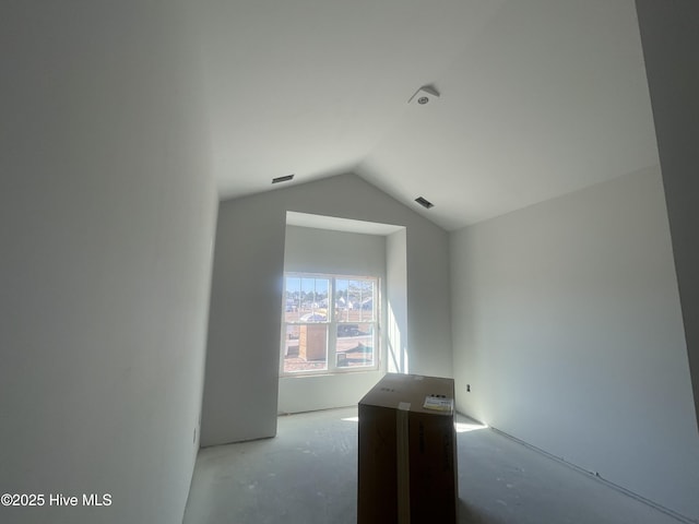 empty room featuring vaulted ceiling