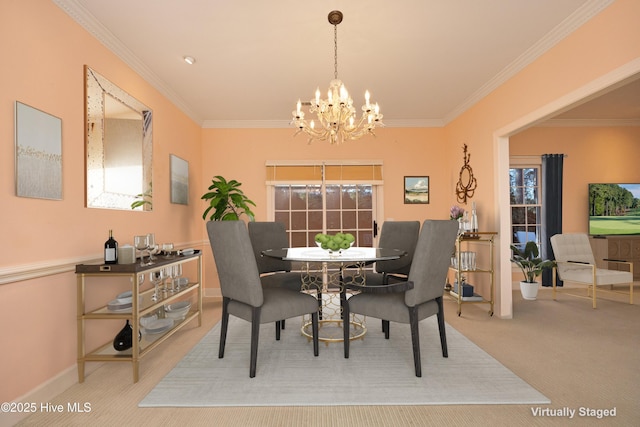 dining space featuring ornamental molding, a chandelier, and carpet flooring