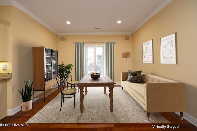 office with dark wood-type flooring and ornamental molding