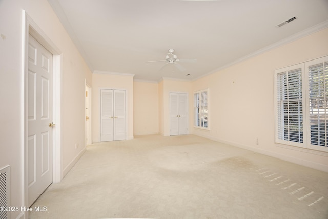 carpeted spare room featuring ceiling fan and ornamental molding