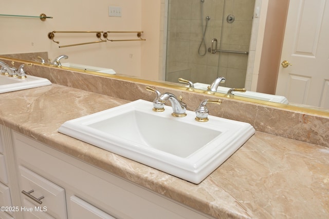 bathroom with an enclosed shower and sink