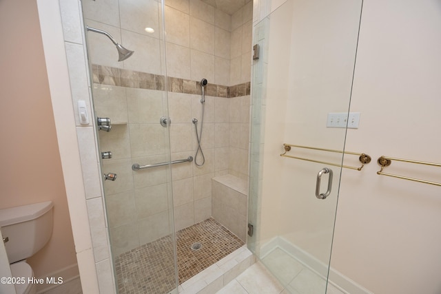 bathroom with walk in shower, tile patterned floors, and toilet