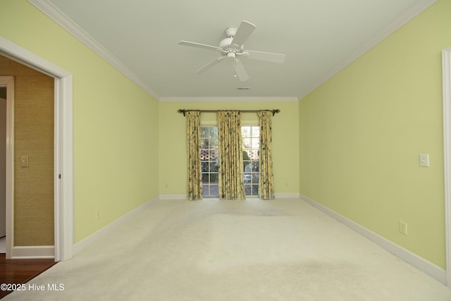 spare room with ceiling fan, carpet floors, and crown molding