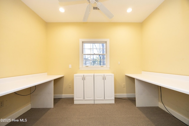 unfurnished office featuring ceiling fan and light carpet