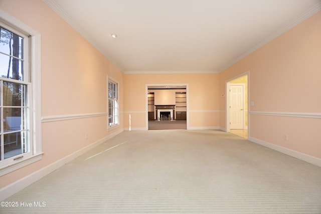 spare room with plenty of natural light, light carpet, and ornamental molding