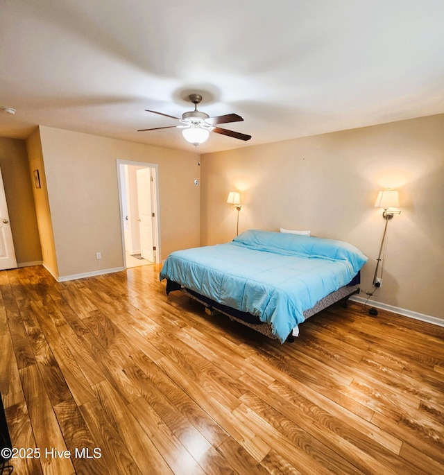 bedroom with ceiling fan and hardwood / wood-style floors