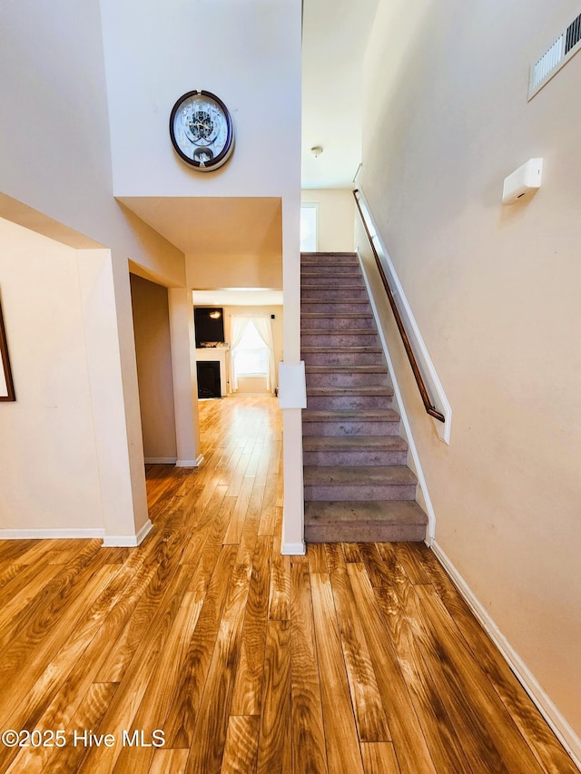 staircase with hardwood / wood-style flooring