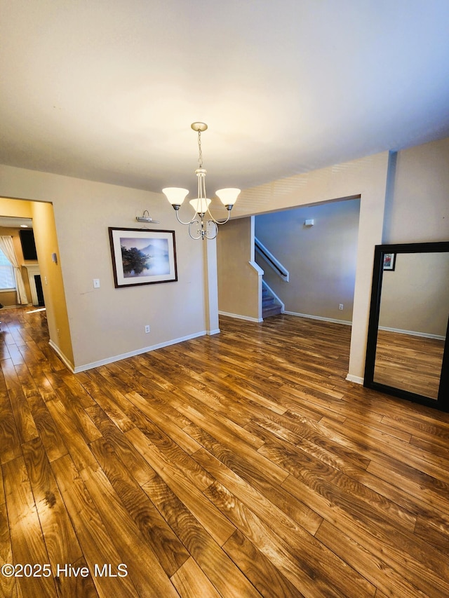 interior space with an inviting chandelier and hardwood / wood-style floors