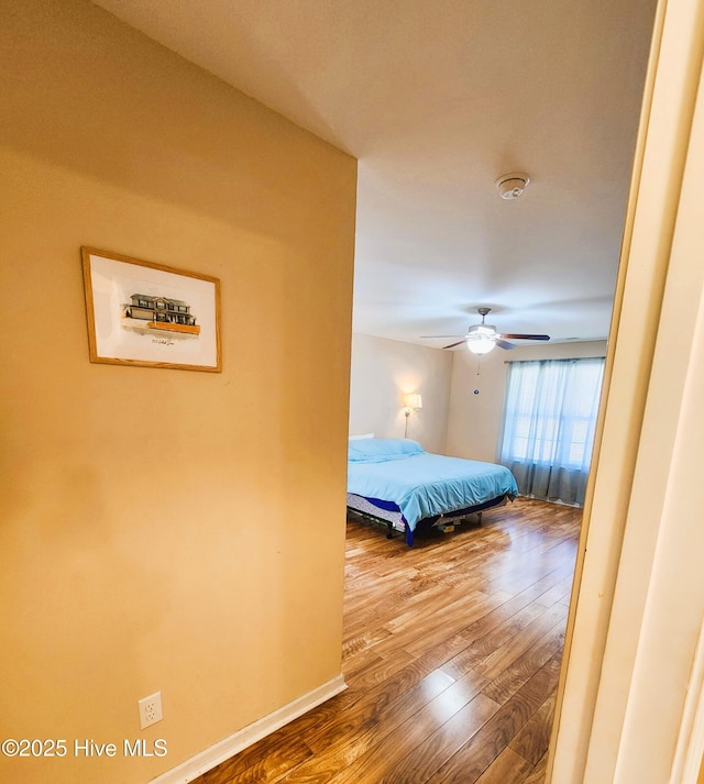 bedroom featuring ceiling fan and hardwood / wood-style floors